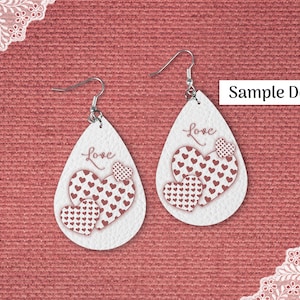 May include: White teardrop earrings with a heart design. Each earring features three hearts in varying sizes, with a pattern of small red hearts. The word "Love" is written in a script font. The text "Sample Design" is also visible.