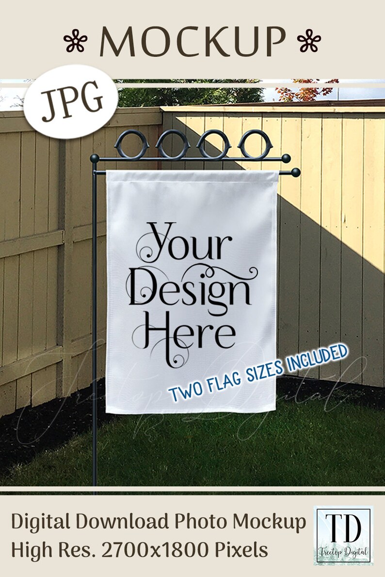 May include: A white garden flag mockup with the text "Your Design Here" in elegant script. The flag is displayed on a black metal stand with a decorative top, set against a backdrop of a wooden fence and green grass. The image includes the text "TWO FLAG SIZES INCLUDED".