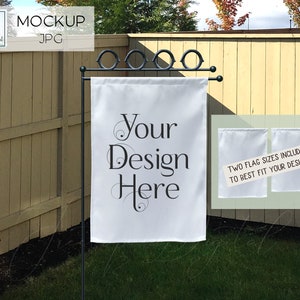 May include: White garden flag with the text "Your Design Here" in black script. The flag is displayed on a black metal stand in a grassy yard. Two additional white flags are shown with text.