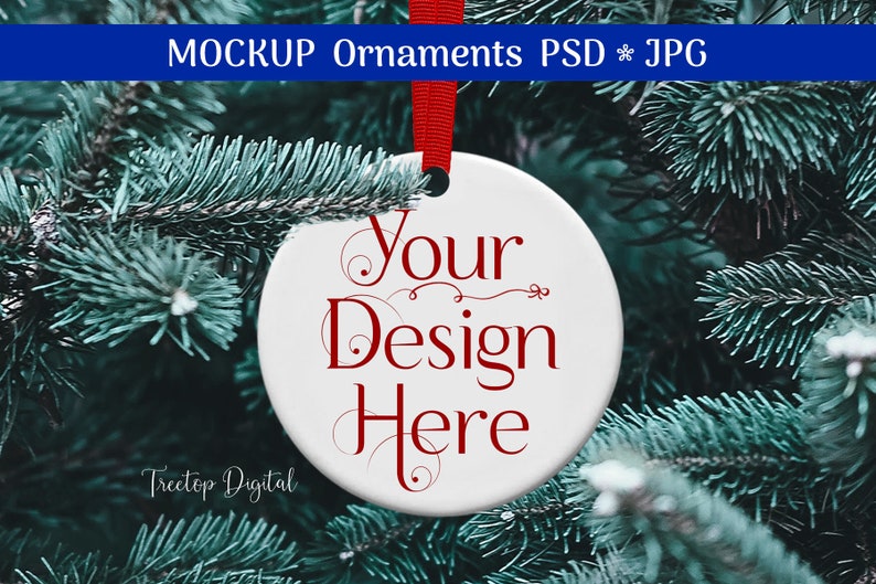 K&ouml;nnte beinhalten: Wei&szlig;er Keramik-Weihnachtsschmuck mit dem Text "Your Design Here" in roter Schrift, aufgeh&auml;ngt an einem roten Band. Der Schmuck befindet sich vor einem Hintergrund aus gr&uuml;nen Tannennadeln.