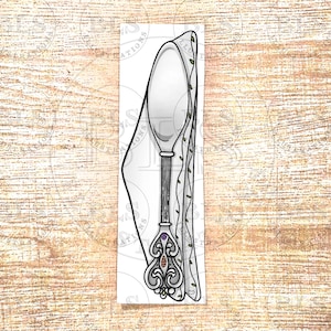 May include: A vertical illustration of a silver spoon with an ornate, decorative handle featuring small embedded red and purple gems. The spoon is partially wrapped in a white cloth napkin with a thin green leaf pattern along the folded edge.