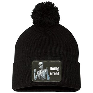 Skeleton Doing Great Pom Pom Beanie, Skull Soft Vegan Leather Patch Men Women Ladies Stretchy Winter Adult Designer Graphic Cap Hat