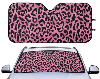 May include: Pink and black leopard print car sunshade. The sunshade is made of a soft, durable material and helps to block out the sun's rays.
