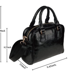 May include: Black leather satchel handbag with a top handle and a detachable shoulder strap. The bag measures 24 cm wide, 34 cm tall, and 21 cm deep.