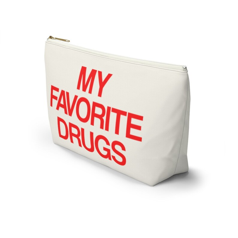 May include: A white canvas zippered pouch with the words "MY FAVORITE DRUGS" printed in red.