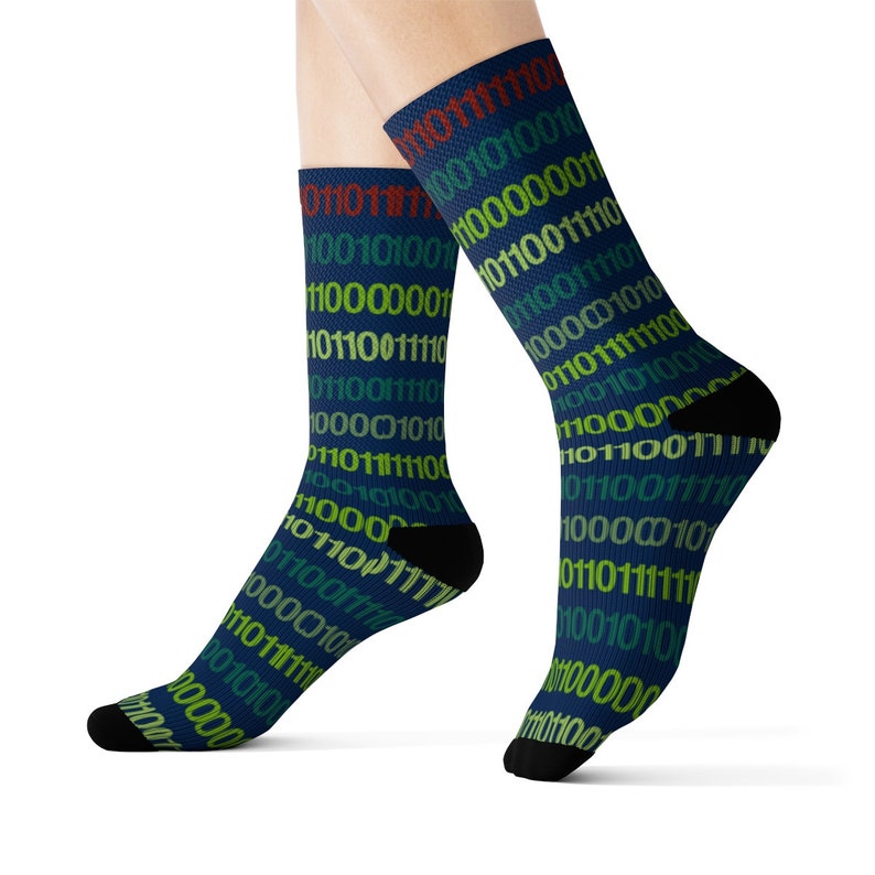 May include: A pair of blue socks with a pattern of colourful binary code. The socks are made of a soft, comfortable material and are perfect for everyday wear.