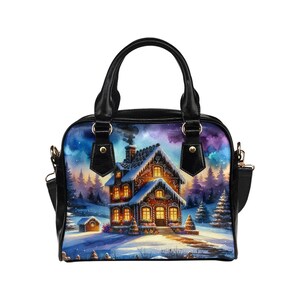 May include: A black handbag featuring a winter scene. The design shows a snow-covered house with lit windows, a snowy landscape, and a starry sky. The bag has black handles and a shoulder strap.