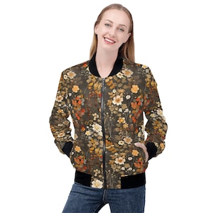 May include: A brown bomber jacket with a floral print featuring orange, yellow, and white flowers. The jacket has a black zipper and black ribbed cuffs and waistband.