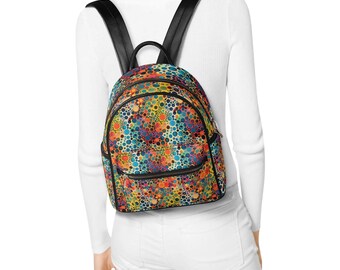 May include: A small backpack featuring a vibrant, multicolored pattern of various sized dots in shades of blue, orange, yellow, and red. The bag includes black leather-like straps, a top handle, and a front zippered pocket with black trim.