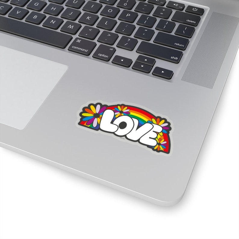 May include: A sticker with a rainbow and flowers surrounding the word "LOVE" in white letters.