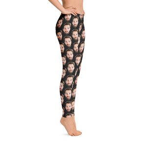 May include: Black leggings featuring a repeating pattern of a man's face. The faces are in a realistic style with brown hair and beards. The leggings are form-fitting and made of a stretchy material.