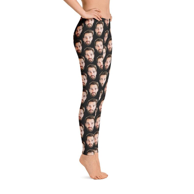 May include: Black leggings featuring a repeating pattern of a man's face. The faces are in a realistic style with brown hair and beards. The leggings are form-fitting and made of a stretchy material.