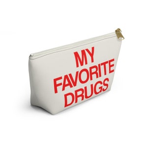 May include: A white canvas zippered pouch with the words "MY FAVORITE DRUGS" printed in red.