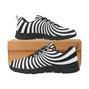 May include: A pair of black and white sneakers with a spiral pattern. The sneakers are on a brown box.