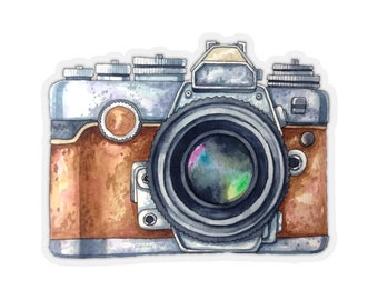 May include: A vintage camera with a brown leather body and a silver lens. The camera has a black lens with a silver rim and a black strap.