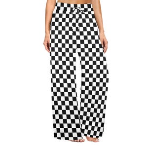 May include: Black and white checkered pattern palazzo pants. The pants have a wide leg design and a drawstring waist. The fabric is a medium weight, suitable for casual wear. The checkered pattern is a classic design.