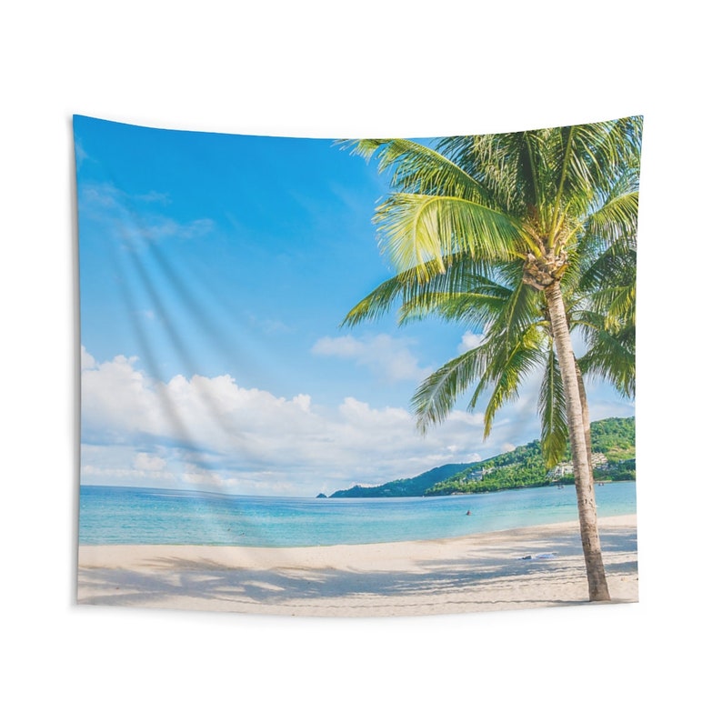 May include: A tapestry featuring a vibrant blue sky with fluffy white clouds, a calm turquoise ocean, and a lush green palm tree on a white sandy beach.