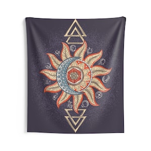 May include: A tapestry with a dark blue background featuring a stylized sun and moon design. The sun is yellow and orange with a red center and the moon is blue with a red geometric shape in the center. The design is surrounded by a circle of smaller symbols.