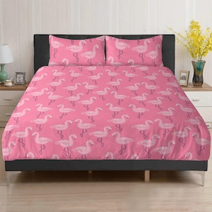 May include: Pink flamingo bedding set with a repeating pattern of pink flamingos on a pink background. The set includes a duvet cover and two pillowcases.