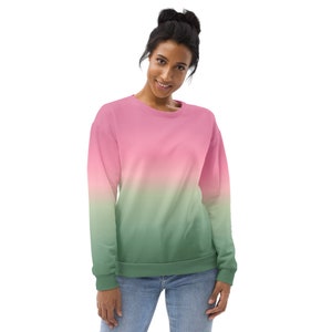 May include: A pink and green ombre sweatshirt. The sweatshirt has a crew neck and long sleeves.