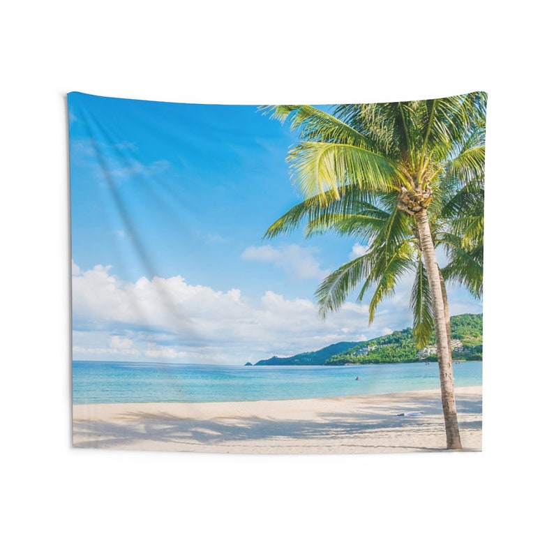 May include: A tapestry featuring a vibrant blue sky with fluffy white clouds, a calm turquoise ocean, and a white sandy beach. A tall palm tree with lush green leaves stands in the foreground, creating a tropical paradise scene.