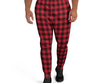 May include: Red and black plaid joggers with a drawstring waist and elastic cuffs. The pants have a classic lumberjack-style pattern. The joggers are made of a soft, comfortable material.