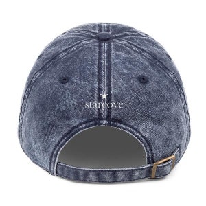 May include: A blue denim baseball cap with a white star and the text "starcove" embroidered on the back.