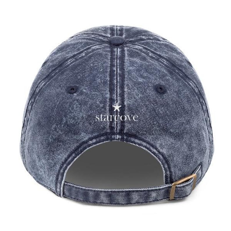 May include: A blue denim baseball cap with a white star and the text "starcove" embroidered on the back.