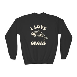 May include: Black sweatshirt with a white graphic of an orca whale and the text "I LOVE ORCAS" in a retro font.