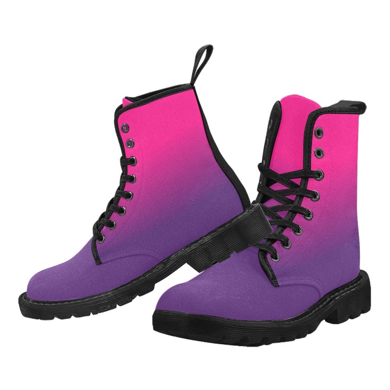 May include: A pair of black lace-up boots with a pink to purple ombre design. The boots have a chunky sole and a rounded toe.