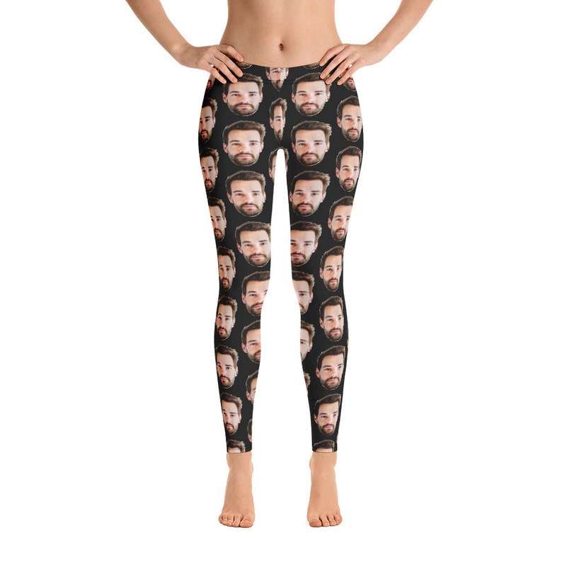 May include: Black leggings featuring a repeating pattern of a man's face. The faces are in a realistic style with dark hair and beards. The leggings are form-fitting and reach the ankles.