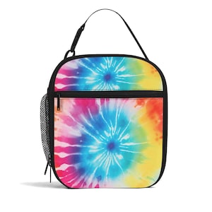 May include: A vibrant lunch bag featuring a tie-dye design in blue, pink, yellow, and orange. It has a black zip, handle, and trim, plus a mesh side pocket. The bag is roughly 23 cm tall and 20 cm wide.