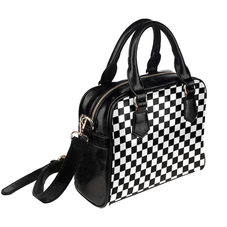 May include: Black and white checkered handbag with a black leather strap and top handles.