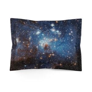 May include: A blue and black pillowcase with a galaxy print featuring a nebula and stars.