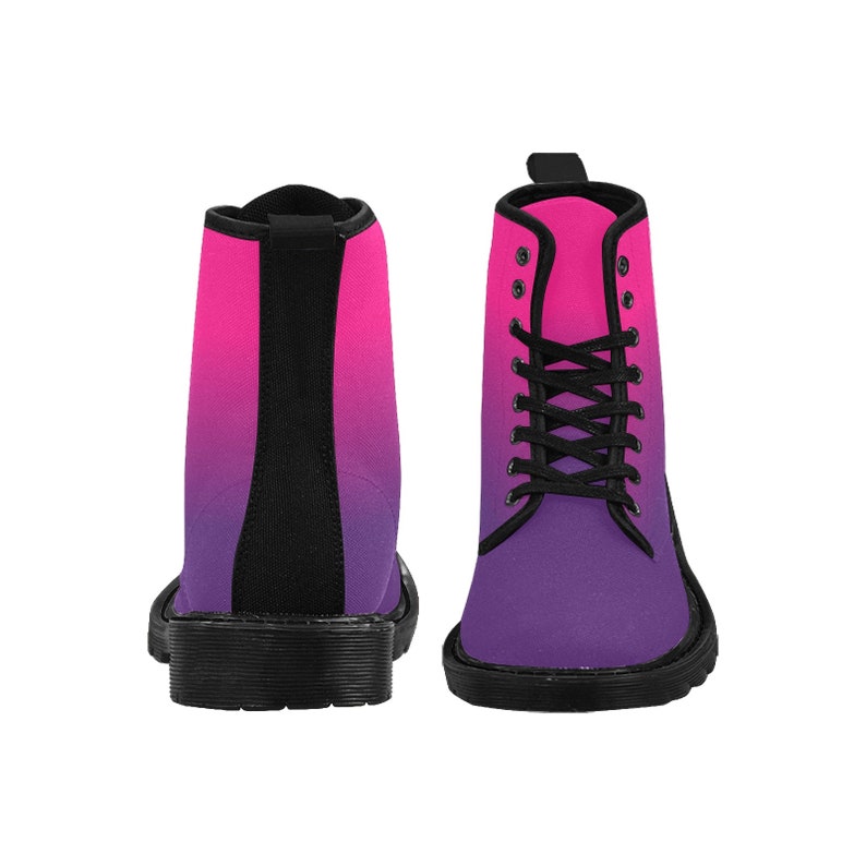 May include: A pair of black lace-up boots with a pink to purple ombre design. The boots have a rounded toe and a thick black sole.