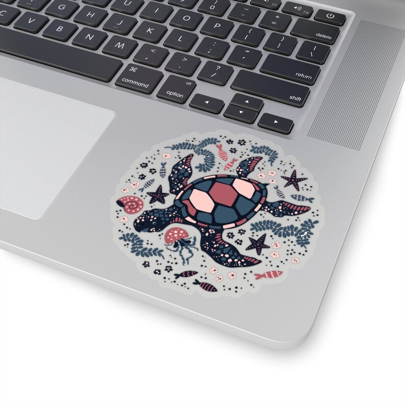 May include: A sticker featuring a stylized illustration of a sea turtle swimming in a circle of ocean life. The turtle is blue, pink, and black with a white background. The ocean life includes starfish, seashells, seaweed, and fish.