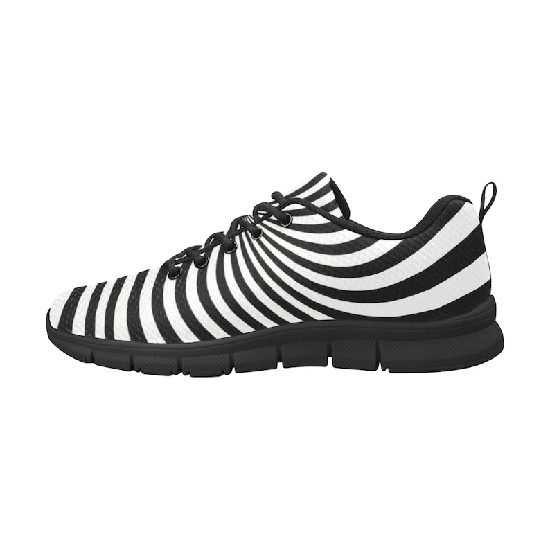 May include: Black and white striped running shoes with a swirling pattern. The shoes have a black sole and a white upper.
