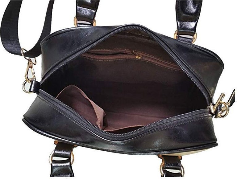 May include: Black leather satchel bag with a zipper closure and gold hardware. The bag has a top handle and a shoulder strap.