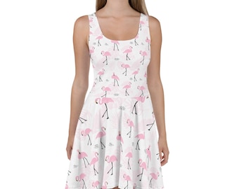 May include: A white sleeveless dress with a pink flamingo print. The dress has a scoop neck and a flared skirt.