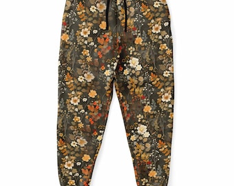 Könnte beinhalten: Eine dunkelgrüne Jogginghose mit einem Blumenmuster, das verschiedene Blumen in Orange-, Gelb-, Weiß- und Rottönen zeigt.