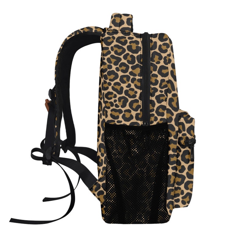 May include: A brown and black leopard print backpack with a black mesh pocket on the side. The backpack has adjustable straps and a zipper closure.