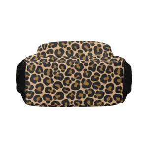 May include: A brown and black leopard print backpack with black straps.
