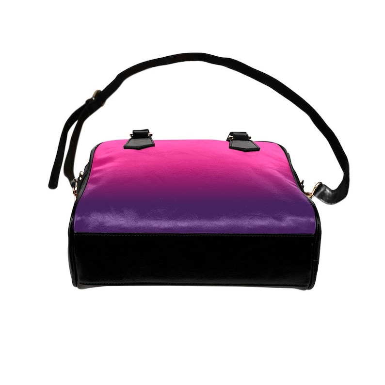 May include: A black leather handbag with a pink to purple ombre design. The bag has a top handle and a long shoulder strap.