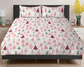 May include: A pink and white bedding set with a repeating pattern of pink and red Christmas trees. The bedding set includes a flat sheet, fitted sheet, and two pillowcases.