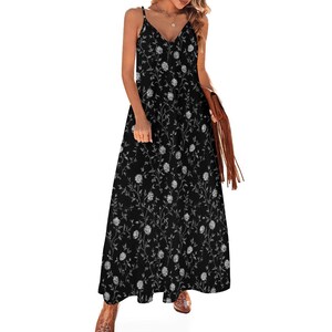 May include: A black maxi dress with a floral pattern. The dress features a V-neckline, spaghetti straps, and a flowing skirt. The floral design is in white and gray, creating a contrasting effect against the black fabric. The dress is suitable for casual or semi-formal occasions.