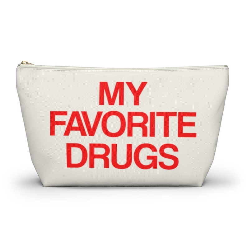 May include: A white canvas zippered pouch with the text "MY FAVORITE DRUGS" in red.