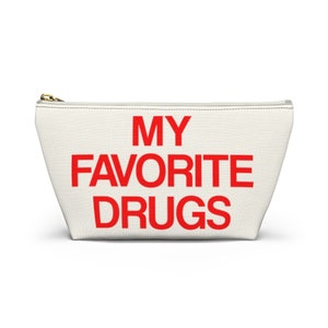 May include: White canvas zippered pouch with the text "MY FAVORITE DRUGS" in red.