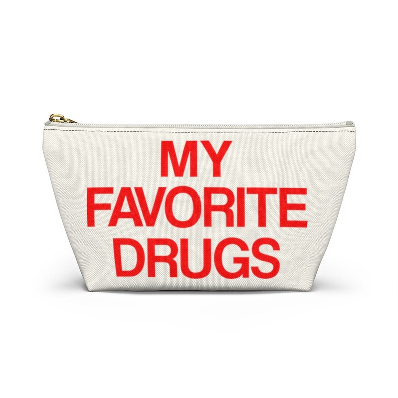 May include: White canvas zippered pouch with the text "MY FAVORITE DRUGS" in red.