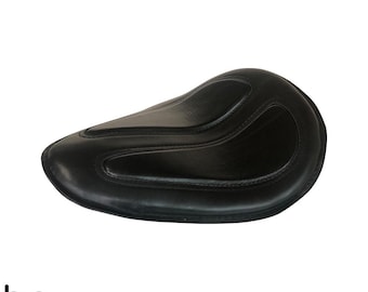 May include: Black leather motorcycle seat with a contoured design.