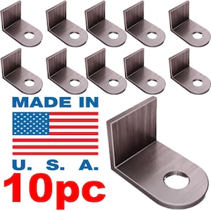 May include: Ten silver-coloured metal L-shaped brackets with a hole in the centre of the short leg. The brackets are arranged in two rows of five. The text "MADE IN U.S.A. 10pc" is printed below the brackets.